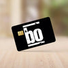 A black card with white text 'bo' and a gold chip icon lying on a wooden surface.
