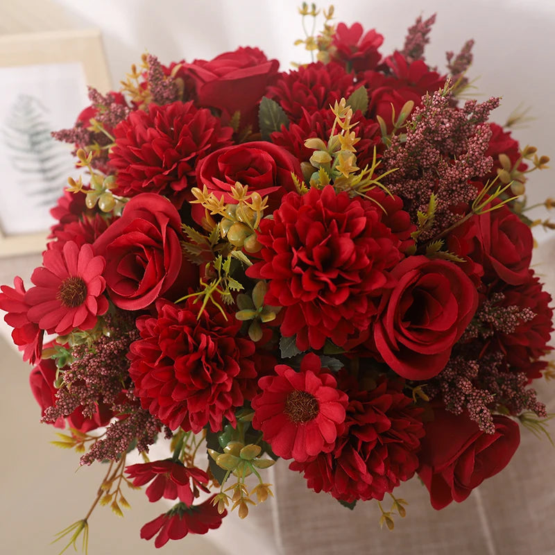 A vibrant bouquet of deep red silk roses and hydrangea flowers.