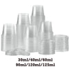 A collection of clear plastic sauce cups and lids in various sizes stacked on a white background.