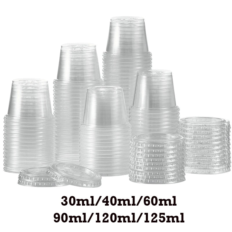 A collection of clear plastic sauce cups and lids in various sizes stacked on a white background.