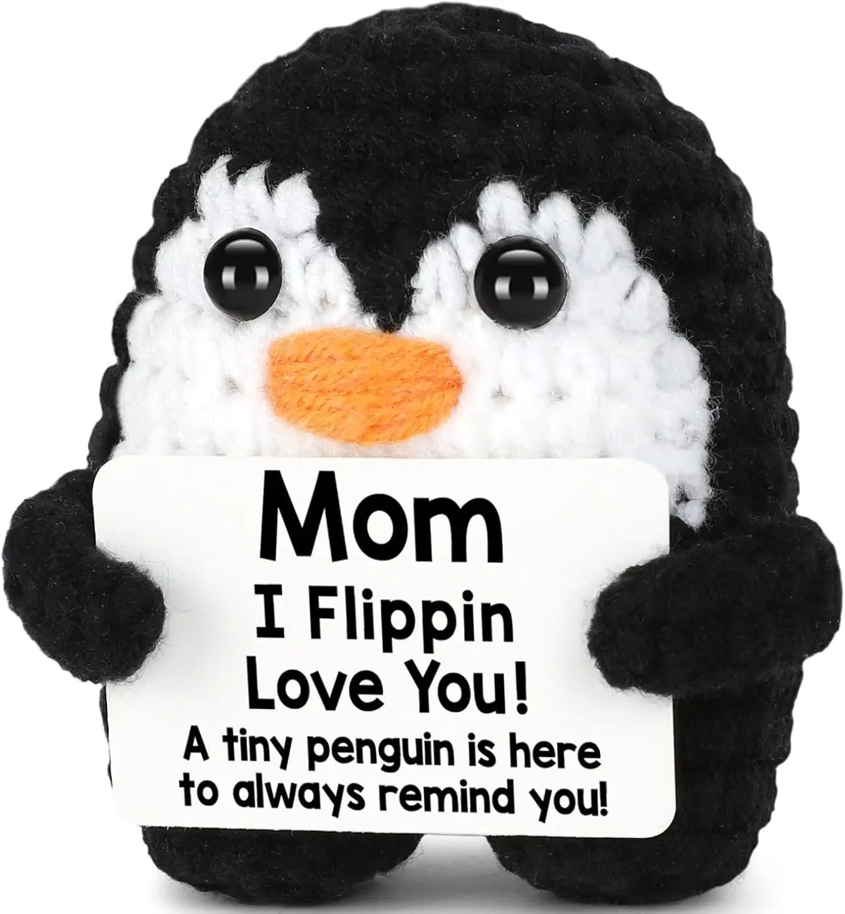 A black and white crochet penguin plush doll with an orange beak and a tag that reads Mom I Flippin Love You