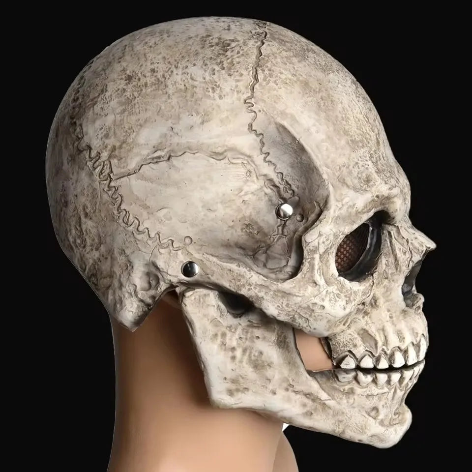 A realistic full-head skull mask with a movable jaw, shown in profile against a dark background.