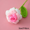 A handmade crochet tulip bouquet featuring pink and white flowers on a green stem.