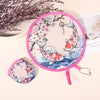 Pink fabric hand fan with a floral design and a hanging chain