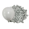 A white latex balloon next to a pile of small, silver-gray latex balloons.