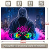 A person wearing a hoodie is holding a gaming controller in front of a cityscape backdrop with pink and purple lighting.