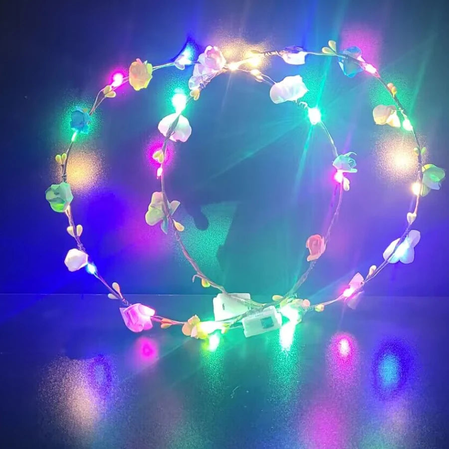 A glowing flower wreath headband with ten LEDs illuminates a dark background.