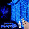 Blue fairy curtain string lights illuminating a building facade for Halloween decoration.