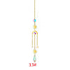 Un long diffuseur de soleil en cristal or, suspendu avec plusieurs éléments pendants.