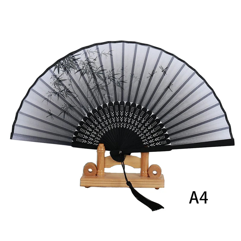 A black and gray lace folding hand fan with a decorative fan section and wooden handle.