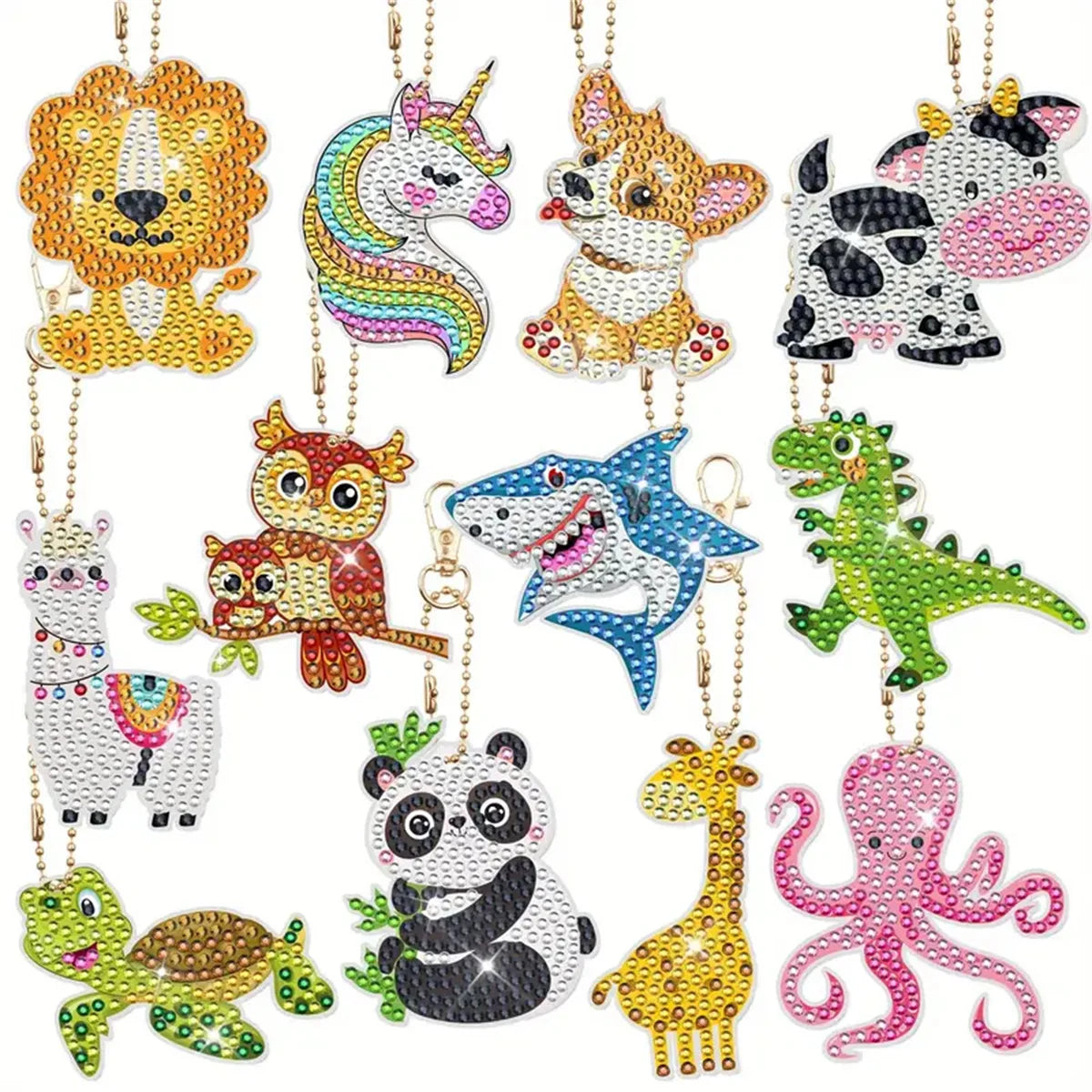 A collection of DIY diamond painting keychains featuring various animal figures like a lion, unicorn, tiger, and shark.