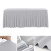 A smooth, gray stretch rectangle tablecloth draped over a table, showing the fabric texture and pleats.