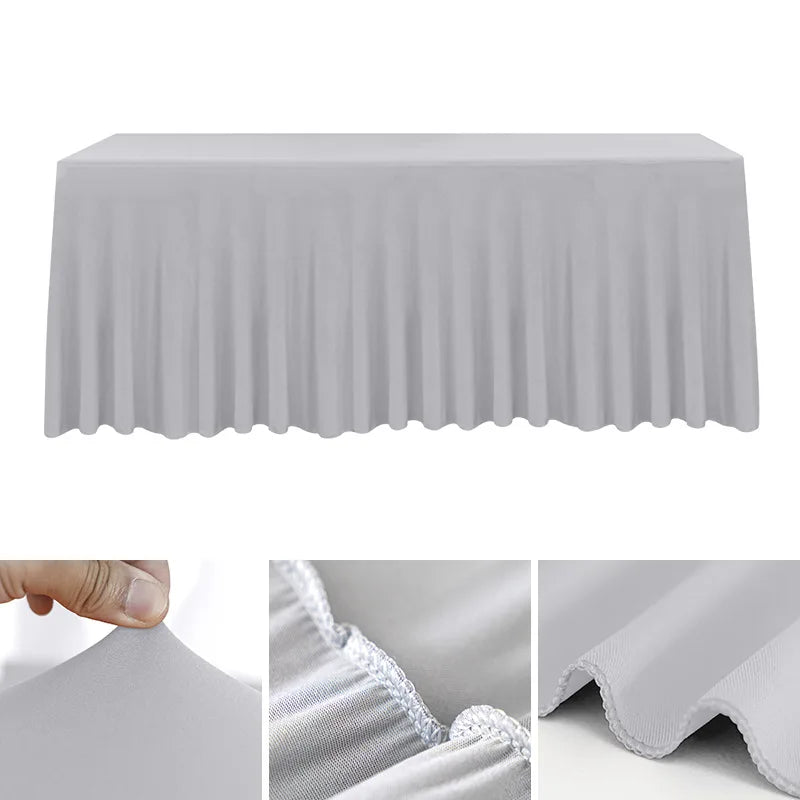 A smooth, gray stretch rectangle tablecloth draped over a table, showing the fabric texture and pleats.