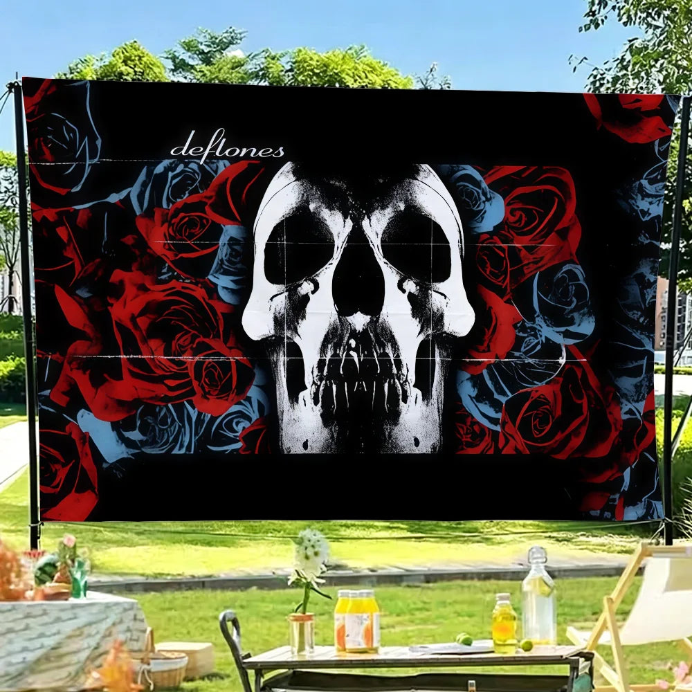 A black flag tapestry featuring a skull design surrounded by red and blue roses.