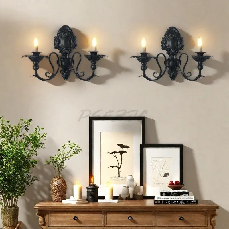 Vintage black wall pendant candle holder with multiple taper candles mounted on a light beige wall.