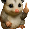 A small resin statue of a mouse with gray and white fur, large eyes, and a pink nose.