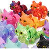 A collection of colorful 3D printed cat figurines with articulated tails in various shades including pink orange yellow and p