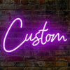 A glowing purple neon sign spelling the word Custom mounted on a brick wall.