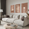 A modern living room features a light sofa, wooden coffee table, and framed retro letter art canvases on the wall.