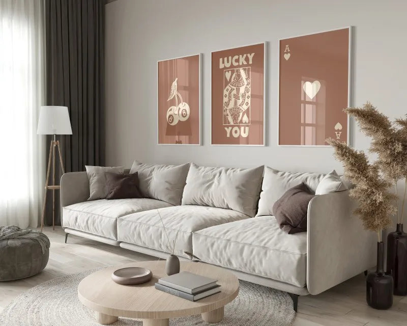 A modern living room features a light sofa, wooden coffee table, and framed retro letter art canvases on the wall.