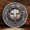 A silver commemorative coin featuring a cross surrounded by virtues like joy peace grace and faith promises