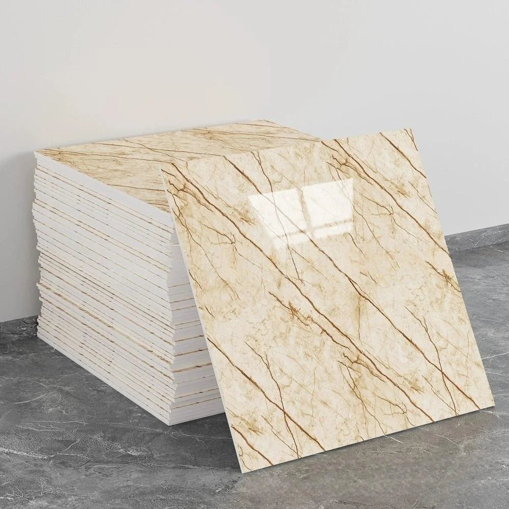 A stack of self-adhesive marble tile stickers featuring a beige and brown veined pattern on a gray surface.