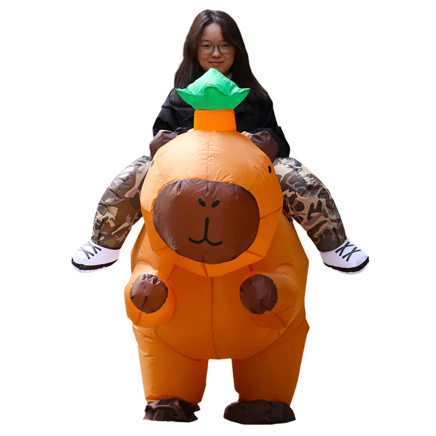 An inflatable orange capybara costume with green ears and a brown face, worn by a person.
