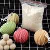 A collection of natural soy wax flakes, including white flakes in a bag and pink and yellow textured wax pieces.