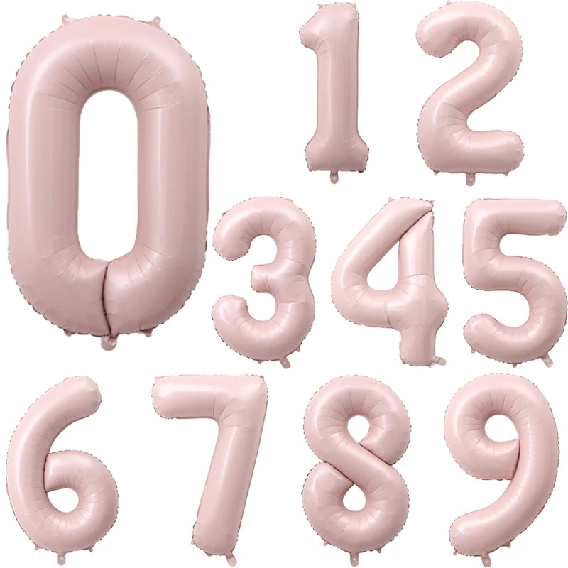 A set of pink foil number balloons forming the digits 0 through 9.