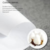 A close-up view of white cotton canvas fabric texture and a small piece of batting or stuffing.