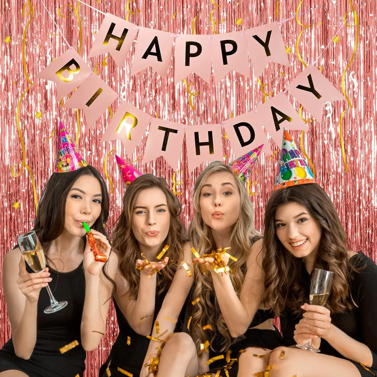 Five young women posing in front of a pink metallic foil fringe curtain backdrop celebrating a birthday