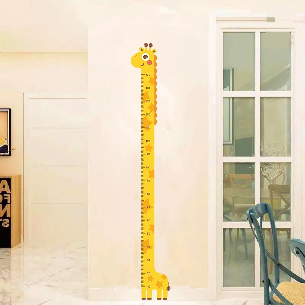 A yellow giraffe-shaped height chart wall sticker with markings, displayed on a white wall next to a window.