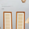 Two vertical solid wood frames with grid designs displayed against a light gray wall.