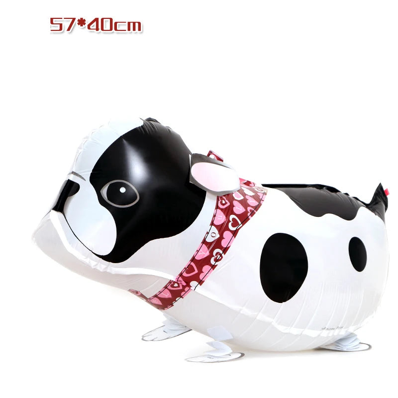 A white and black cartoon cow foil balloon shaped like a farm animal for party decor.
