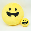 A bright yellow, smiling plush doll resembling a happy face.
