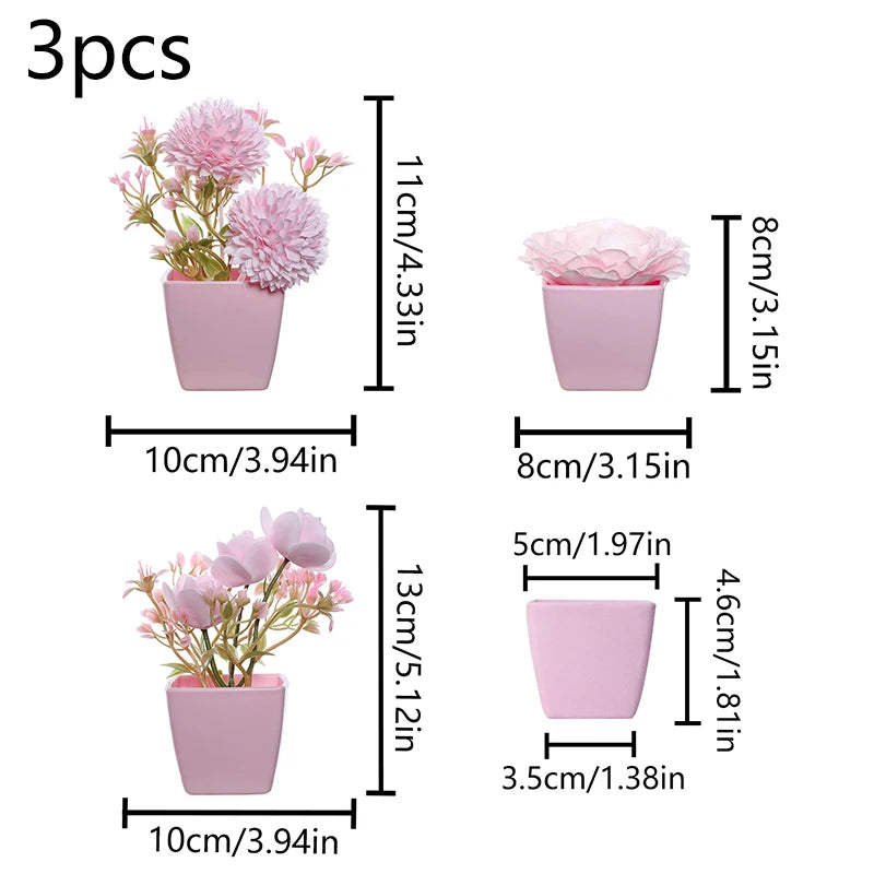 Three small pink faux bonsai plants in rectangular pots with varying heights and sizes.
