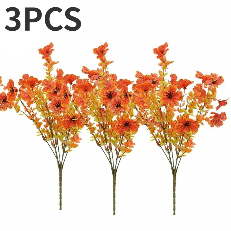 Three bunches of artificial silk flowers in vibrant orange and yellow hues.