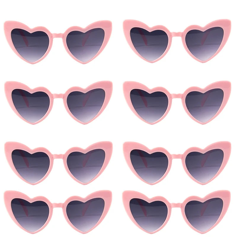A set of pink heart-shaped sunglasses with dark lenses for special events.