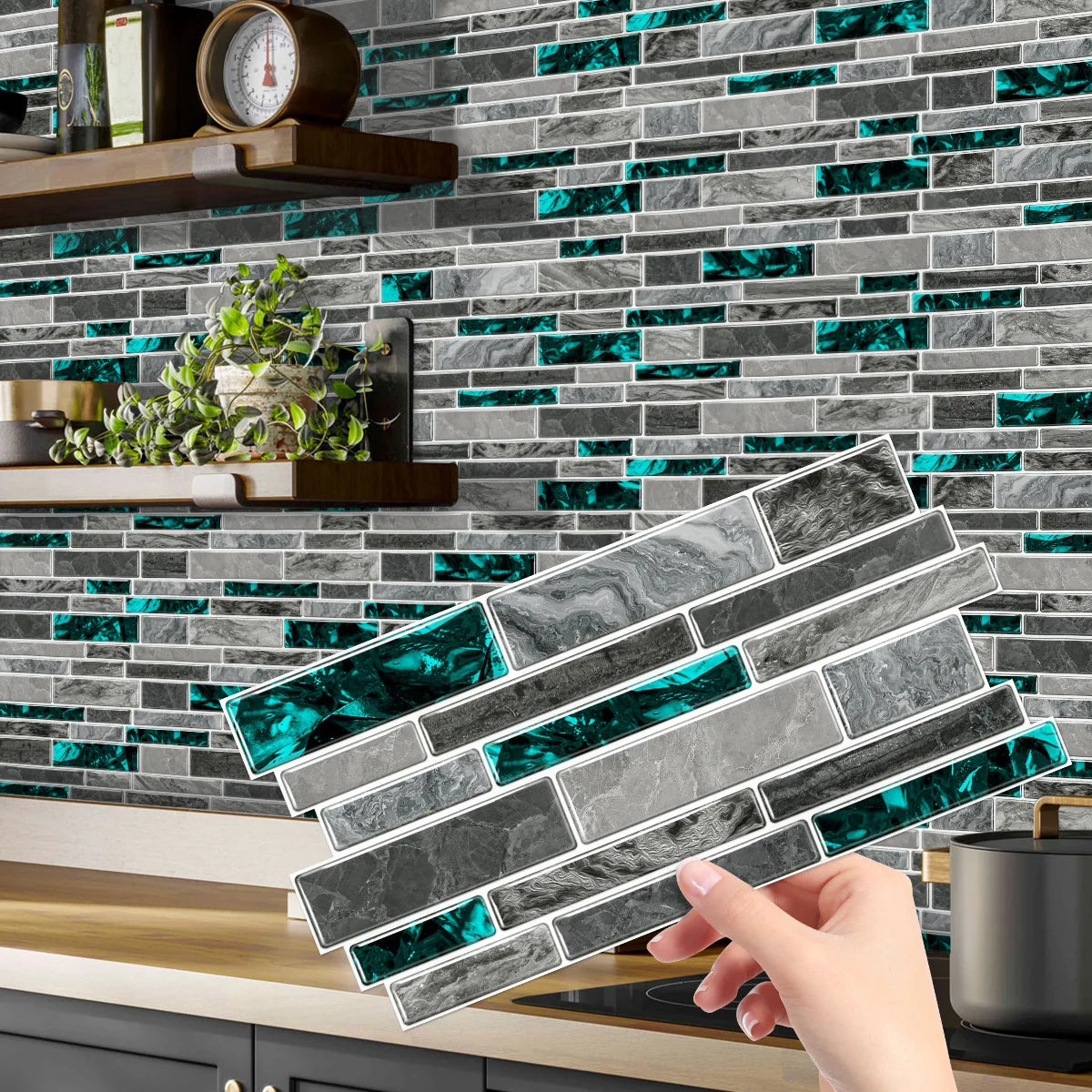 A hand holds a rectangular crystal film marble wall decal against a gray and teal subway tile background.