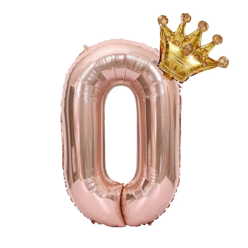 Rose gold foil balloon shaped like the number zero with a gold crown on top
