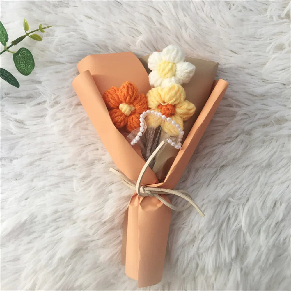 A bouquet of handcrafted crochet sunflowers in orange and yellow yarn, wrapped in kraft paper.