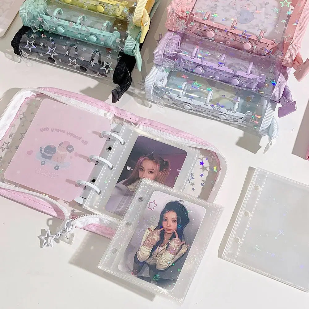 A collection of glitter star card binders and clear plastic storage cases in pink, purple, and iridescent colors.