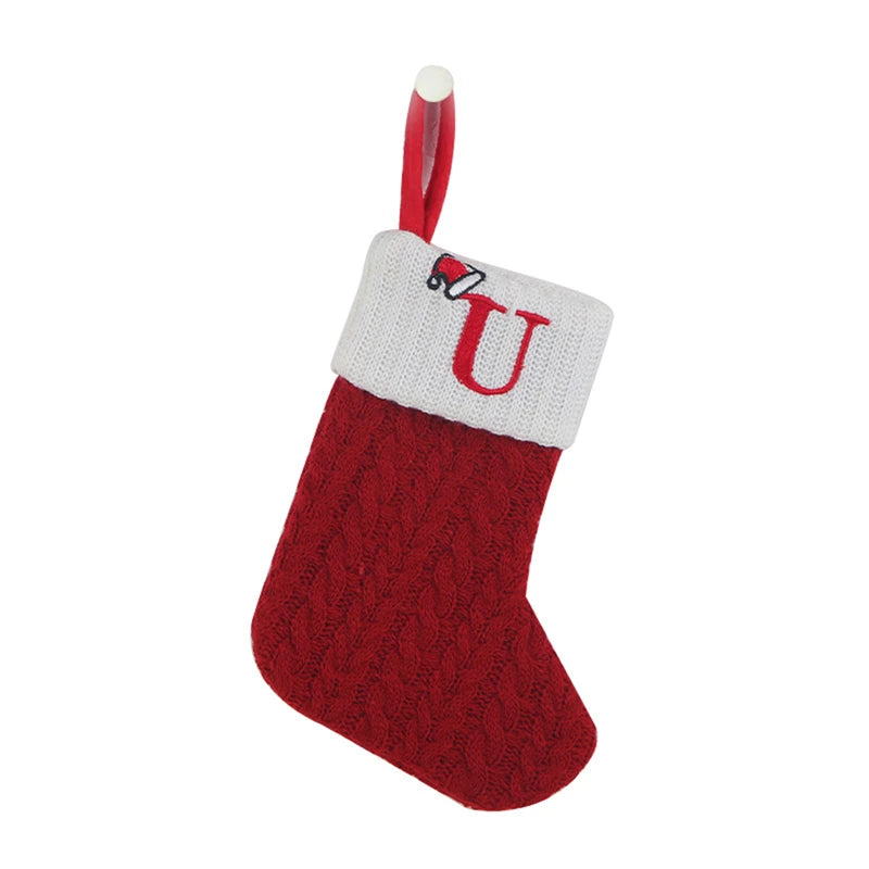 A red knitted sock with a white U letter decoration and a red loop for hanging.