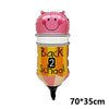 Pinkes Folienballon in Form eines lächelnden Gesichts mit schwarz-weißen Streifen, dekoriert mit dem Text „Back to School“.