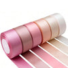 Roll of satin silk ribbon in various shades of pink and peach, displayed horizontally.