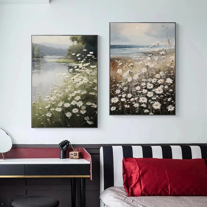 A framed oil painting depicting a serene river landscape with fields of white daisies.