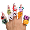 A hand displays various Halloween glow rings featuring spooky characters and colors like orange, purple, green, and white.