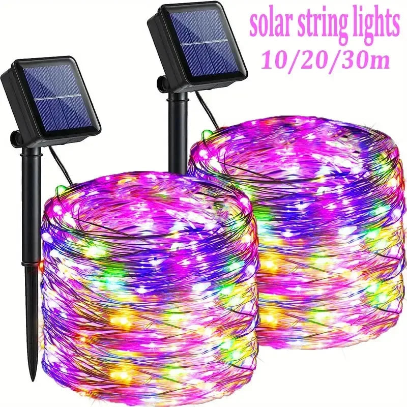 A bundle of colorful LED string lights wrapped around a cylindrical object, powered by solar panels.