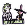 A black enamel pin badge featuring a cartoon character with green hair and a pink nose, with the text BEETLEJUGO!