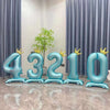 Large blue foil number balloons spelling out 43210 arranged in a row against a light background